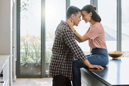 Being deeply loved by someone gives you strength. a couple spending time together in the kitchen at...