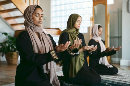 This has been a time of prosperity. a group of muslim women praying together.