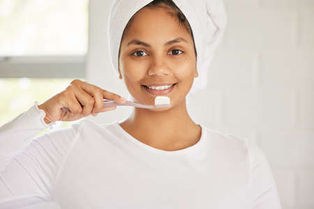Lying through your teeth does not count as flossing. a beautiful young woman brushing her teeth in...