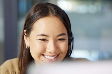 Shes a stellar customer service rep. a young businesswoman using a computer while working in a call centre.の写真素材