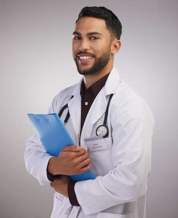 Im ready to save some lives. a handsome young doctor standing alone in the studio and holding a...
