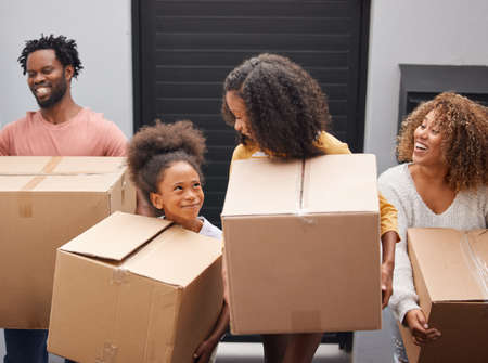 A mans house is his castle. a family carrying boxes into their new home.の写真素材