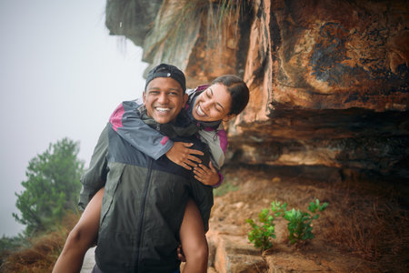 Life with you is nothing but a beautiful adventure. a young couple wearing their rain jackets while out hiking.の写真素材