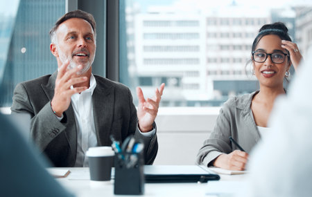Theyre always thrilled to share their big ideas. a group of businesspeople having a meeting in an office.の写真素材