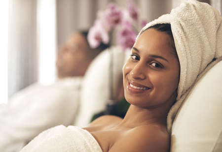 A spa day is money well spent. a woman wearing a towel around her head while enjoying a spa day.