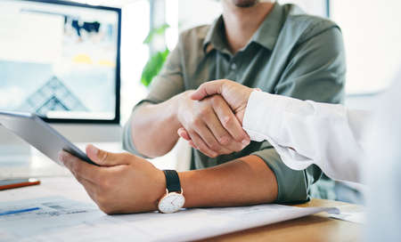 Im excited to be working with you. two unrecognizable businesspeople shaking hands in an office.