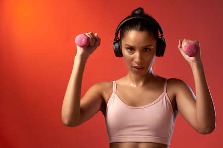You earn it through a lot of hard work. Studio portrait of a sporty young woman exercising with...