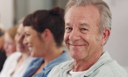 Look at my beautiful family. a mature man relaxing on the couch with his family.の写真素材