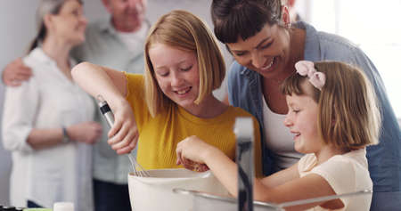 Thank you for helping us mom. a family baking together in the kitchen.