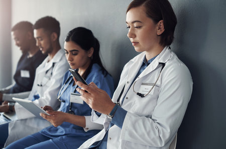 DOCTOR ,such a mind blowing word. a group of doctors sitting against a grey background at work.の写真素材