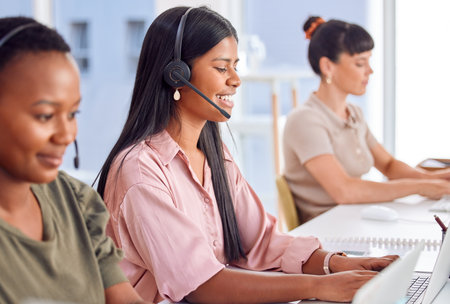 Thank you for your call, let me know if theres anything else. a businesswoman wearing a headset while working in a call centre.の写真素材