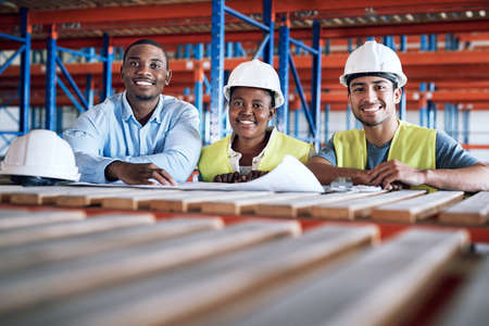 The right people with the right skills. a group of builders having a meeting at a construction site.の写真素材