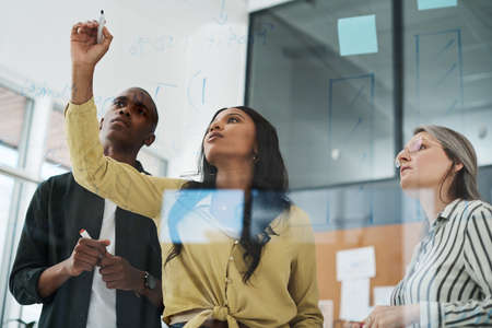 Naturally submissive to who we trust to lead. a group of businesspeople brainstorming in a modern...