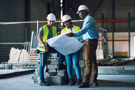 Youve got the dream, theyve got the draft. a group of builders having a meeting at a construction...