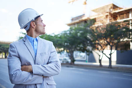This city is so full of potential. a young businessman at a construction site.