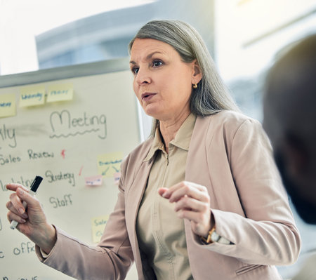 Last week our profits dipped slightly. a mature businesswoman giving a training presentation.の写真素材