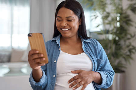 I wonder if people know how much their well wishes mean to me. a pregnant woman using her cellphone...