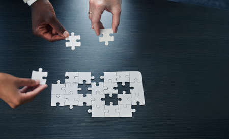 Building a future of greatness. business coworkers completing a puzzle together.