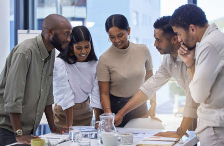 Coming up with a plan they can all agree on. a group of businesspeople having a meeting in a...