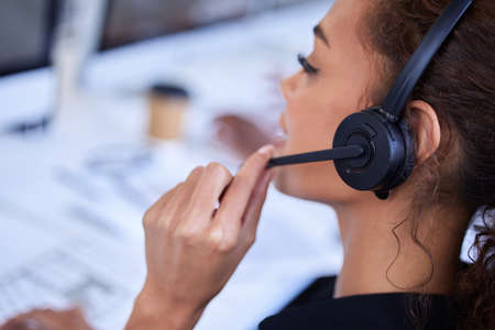 Pitching a new deal to a client. a young businesswoman working in a call centre.
