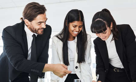 Teamwork makes every strategy work. Low angle shot of businesspeople working together in an office.
