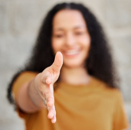 Allow me to introduce myself. a young woman extending her hand for a handshake.の写真素材