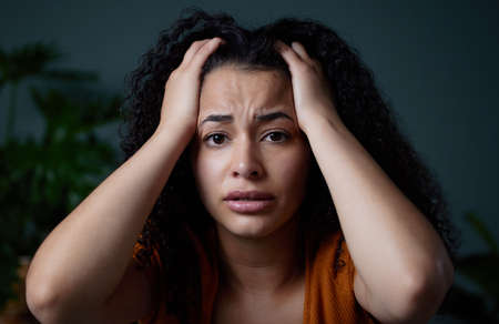 What do I do now. a young woman feeling unhappy at home.の写真素材