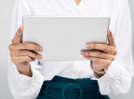 Upgrade your tech, upgrade your business. Studio shot of an unrecognisable businesswoman using a...