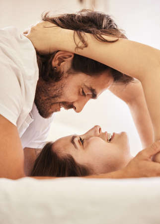 Here is where I belong. a young couple having an intimate moment on the bed at home.