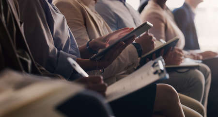 Typing out a few key notes from the talk. Closeup shot of an unrecognisable businesswoman using a digital tablet during a conference in an office.の写真素材