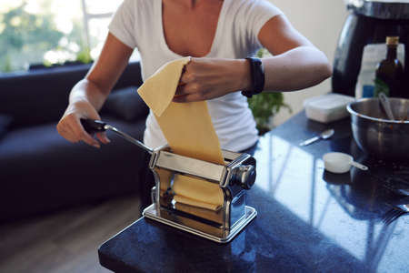 Homemade is always best. an unrecognizable young woman cooking homemade pasta at home.