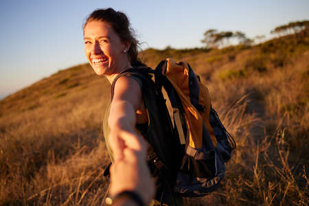 Theres no other place Id rather be. a young couple hiking on a mountain during the day.の写真素材