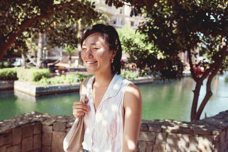 Travel offers experiences. an attractive young woman exploring the city alone during the day.の写真素材