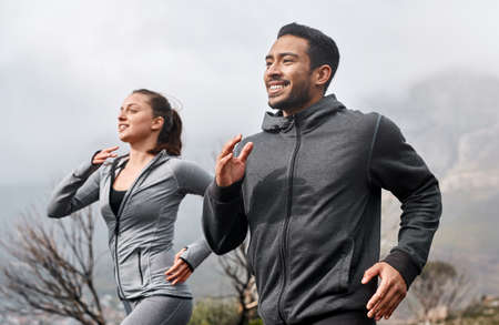 Trail running improves every element of your fitness. a sporty young man and woman running together...