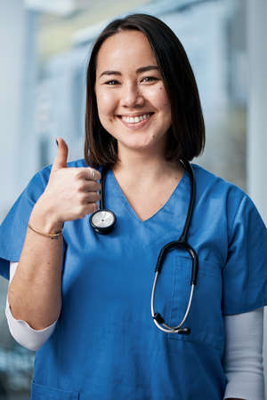 Youre looking much better already. Portrait of a medical practitioner showing thumbs up in a hospital.の写真素材