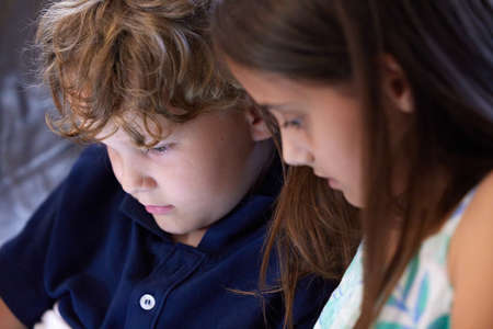 Theres no time for boredom if you have a sibling. an adorable little boy and girl sitting together at home.の写真素材