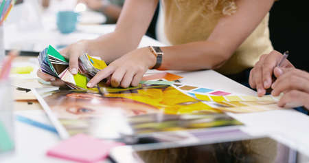 Their talents match as well as the colour scheme. two unrecognisable businesspeople going through...