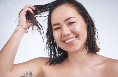 I can already feel the difference. a beautiful young woman posing against a white background.の写真素材