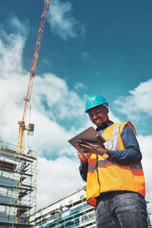 The smartest project management solution. a young man using a digital tablet while working at a...