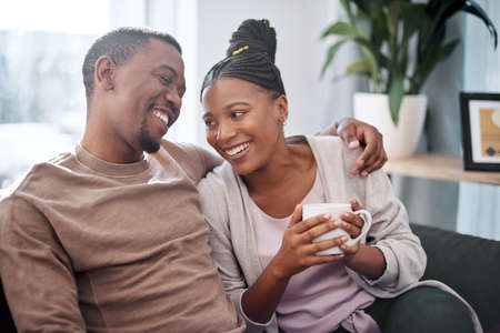 Being with you is true joy. a young couple relaxing on a sofa at home.