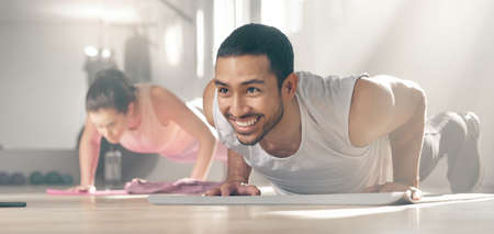 Its hard work but its also fun. two young athletes working out together at the gym.