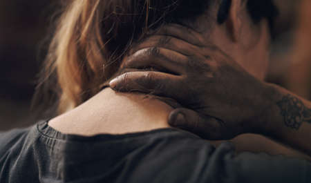 Overexertion comes at a cost. a young woman experiencing neck pain while working at a foundry.の写真素材