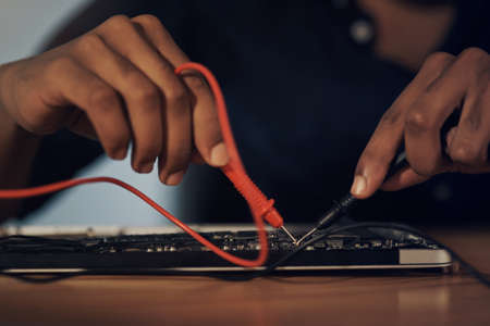 The guy to give your tech an upgrade. an unrecognisable technician repairing computer hardware.の写真素材