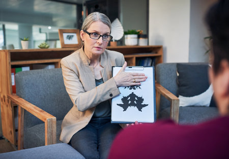 Time to change the way you look at life. a mature psychologist conducting an inkblot test with her...