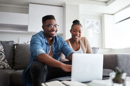 Budgeting has become such a breeze for them. a young couple using a laptop together at home.