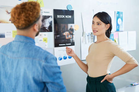 Catching up with new trends. a young businesswoman having a discussion with a colleague in an...
