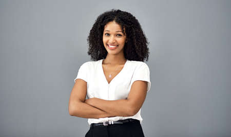Confidence keeps you ahead of the game. Studio shot of a confident young businesswoman standing...