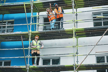 Coordinating staff and resources to deliver on proposed plans. a group of people working at a...