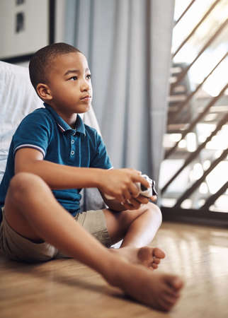 Racing games are my favourite. a young boy playing video games at home.