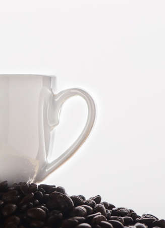 Coffee beans the world to me. Closeup shot of a cup on a pile of coffee beans.の写真素材